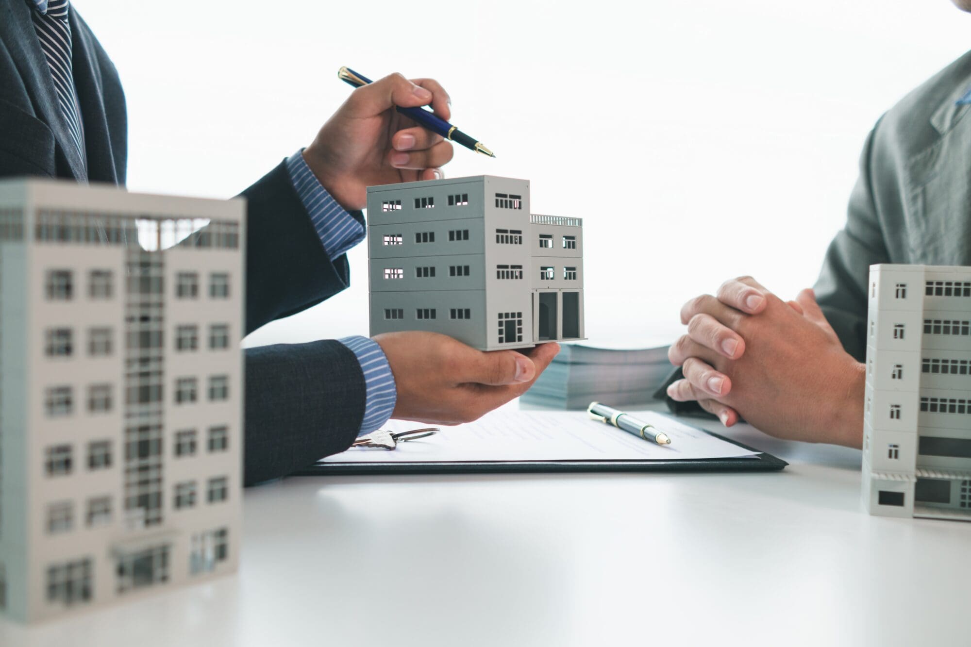 Florida condominium building with a commercial general liability insurance policy and policy endorsements on a desk, representing cross liability and separation of insureds coverage.